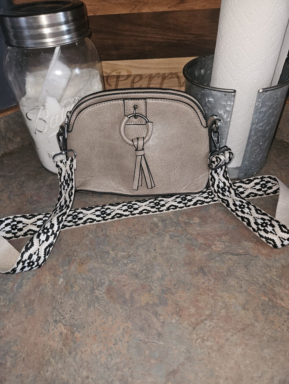 Taupe Crossbody Bag with Decorative Ring and Patterned Strap